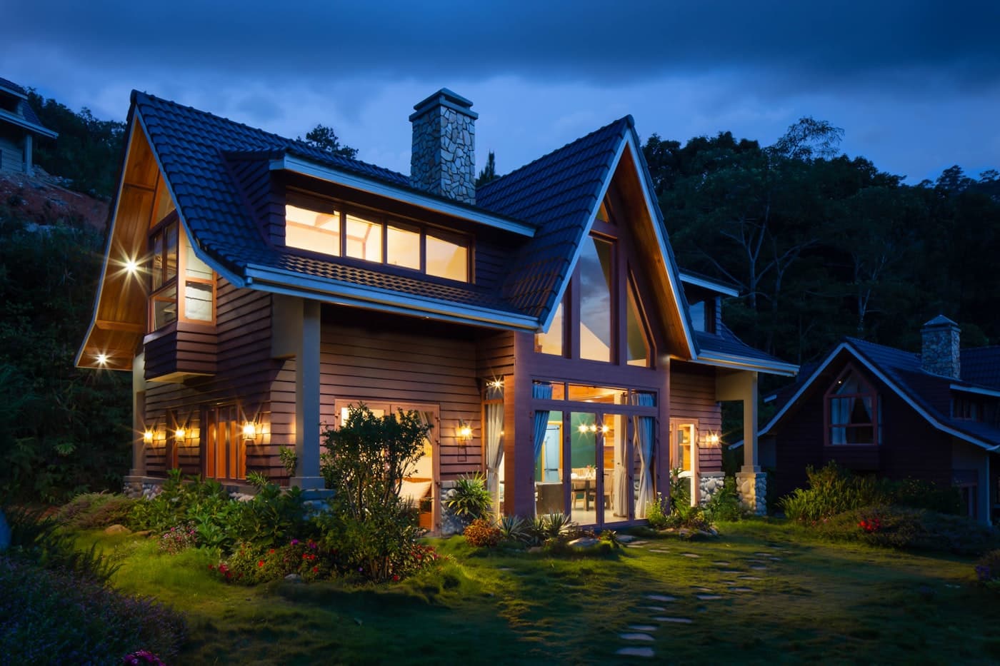 Detached house lit at dusk after site handover