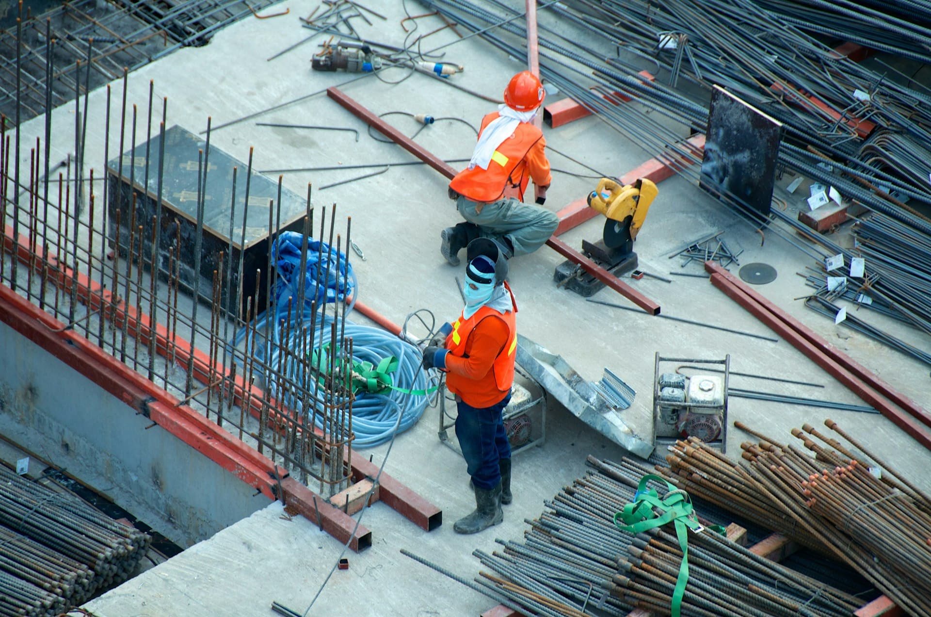 ARBUATTI CONSTRUCTIONS workers on a reinforced-concrete structural site, rebar laid out