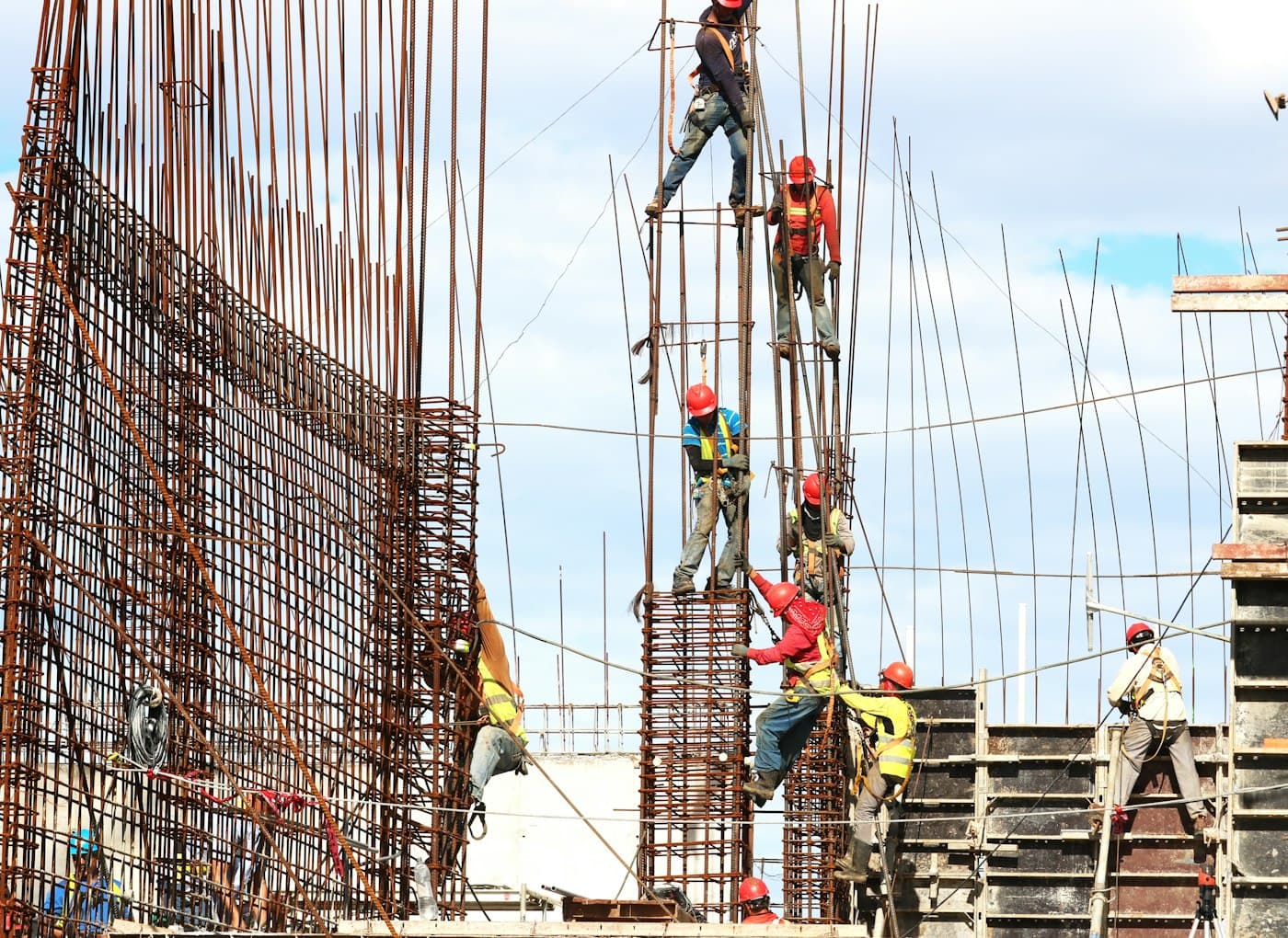 Workers on a reinforced-concrete column structure and rebar